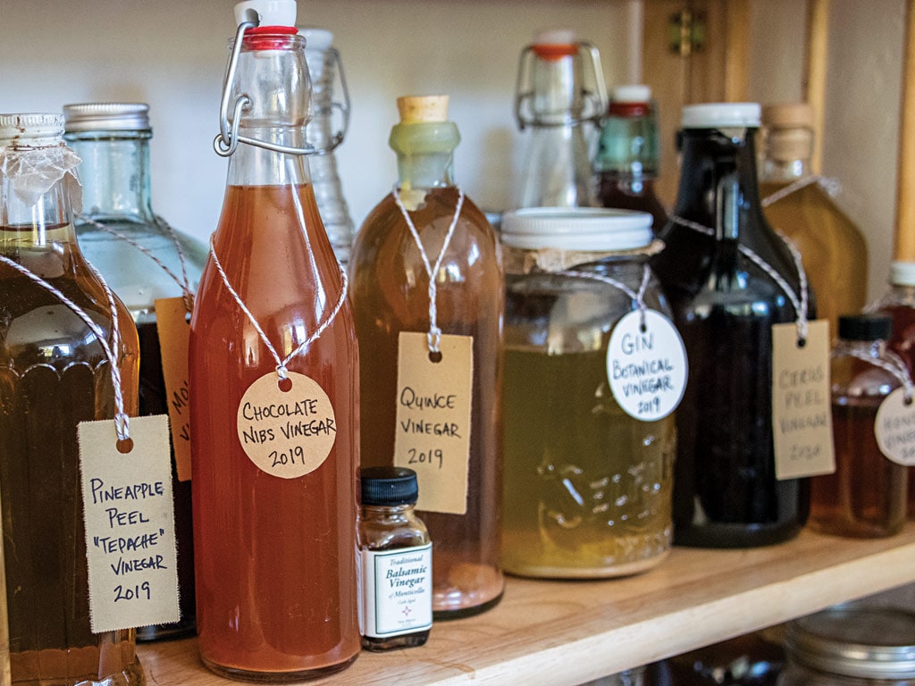 Dozens of vinegars bottles on the shelf