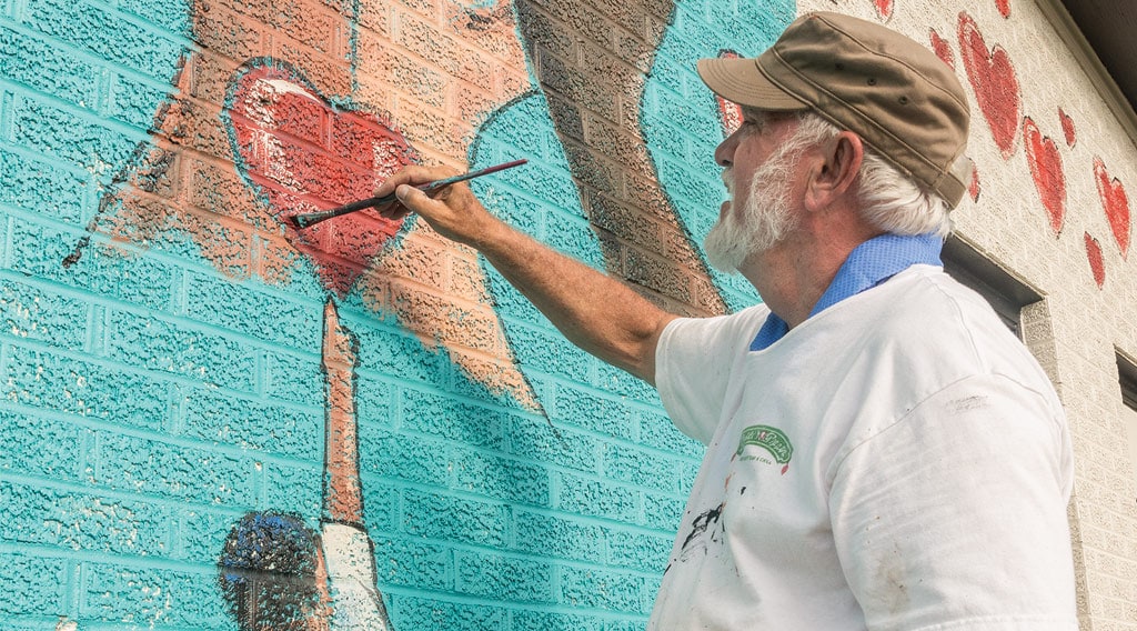 Man painting mural