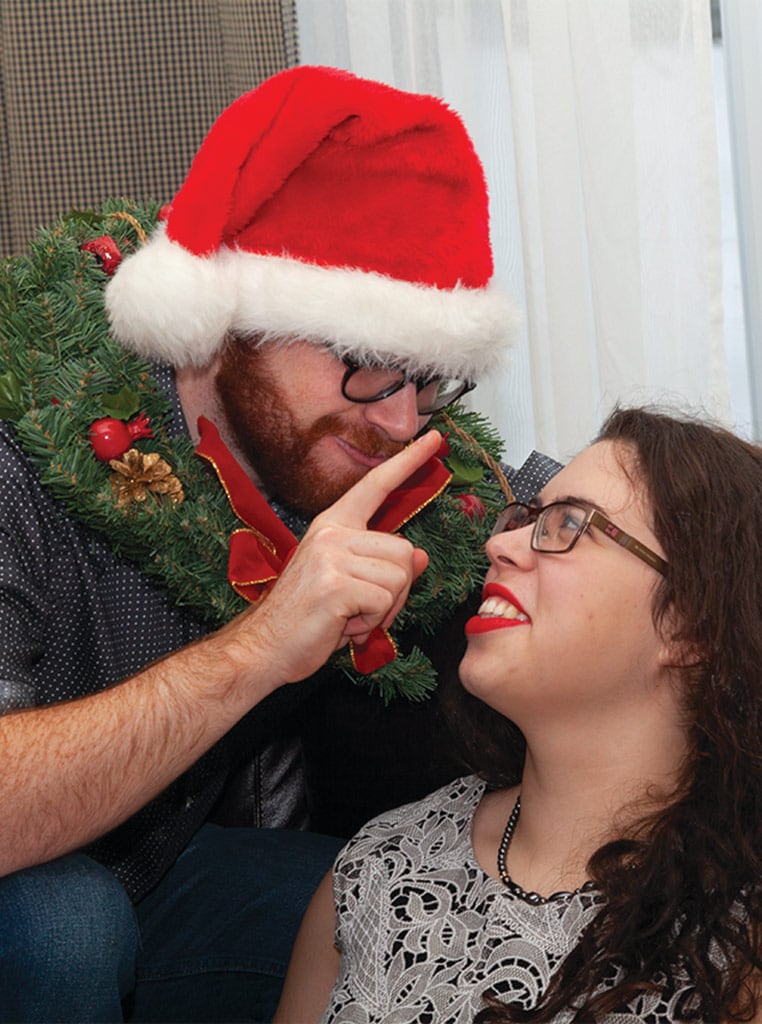 man booping woman on nose