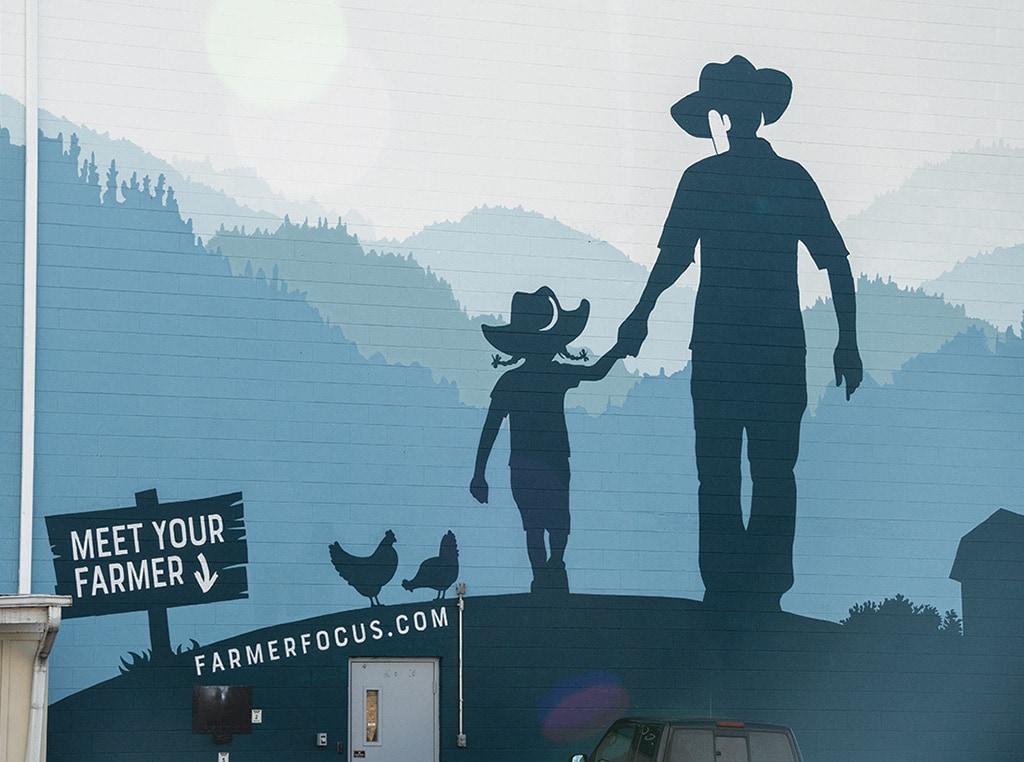 a mural of a man holding a little girl's hand