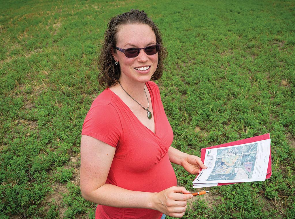 Erin Ogle stands in field