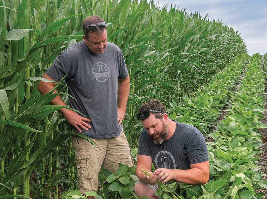 Farmer Steve Killpack and client Chris Johnson standing in a field