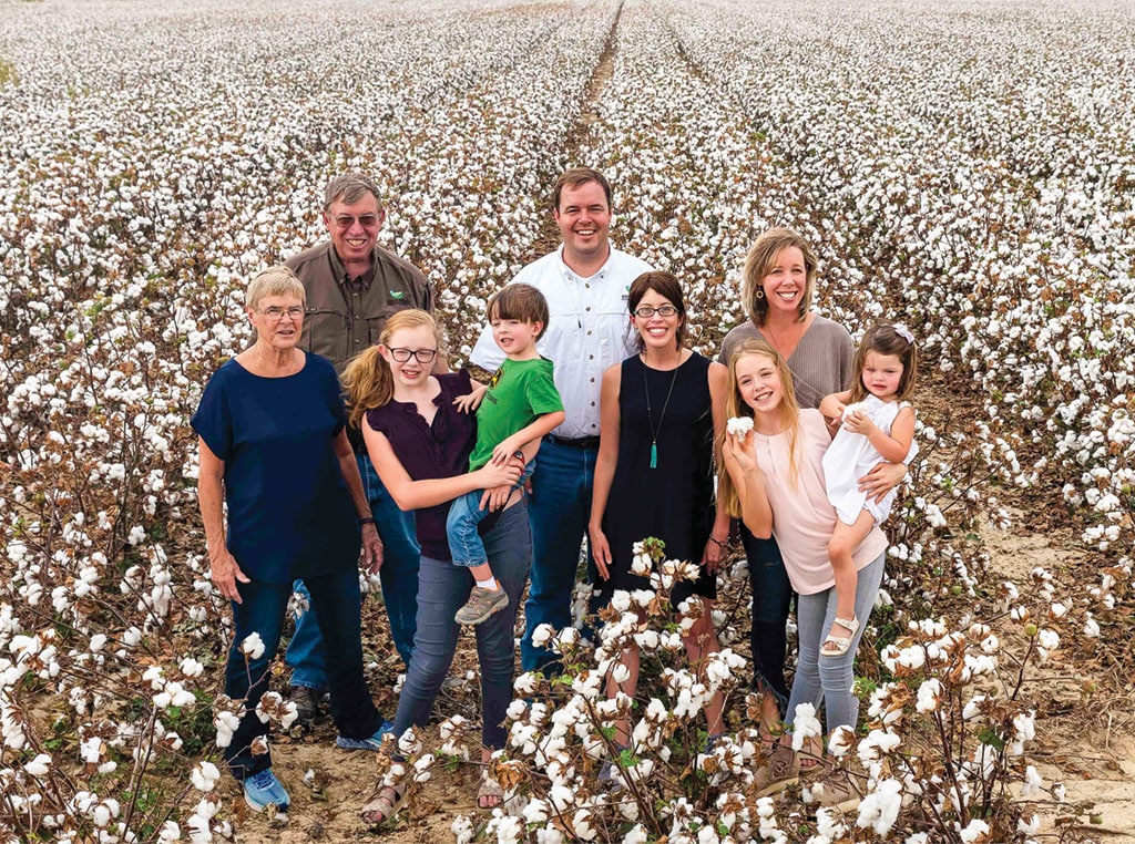 Jeremy and Elizabeth Jack (in white and black in center) surrounded  by their family – all an integral part of their operation.