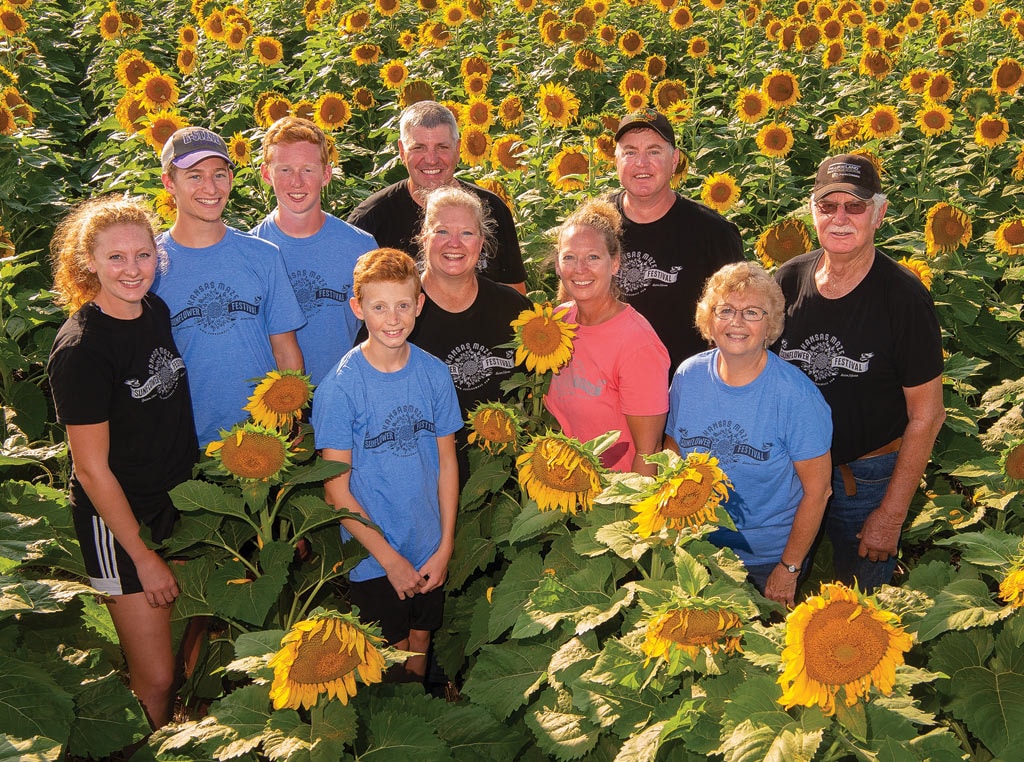 Family in field of sunflowers