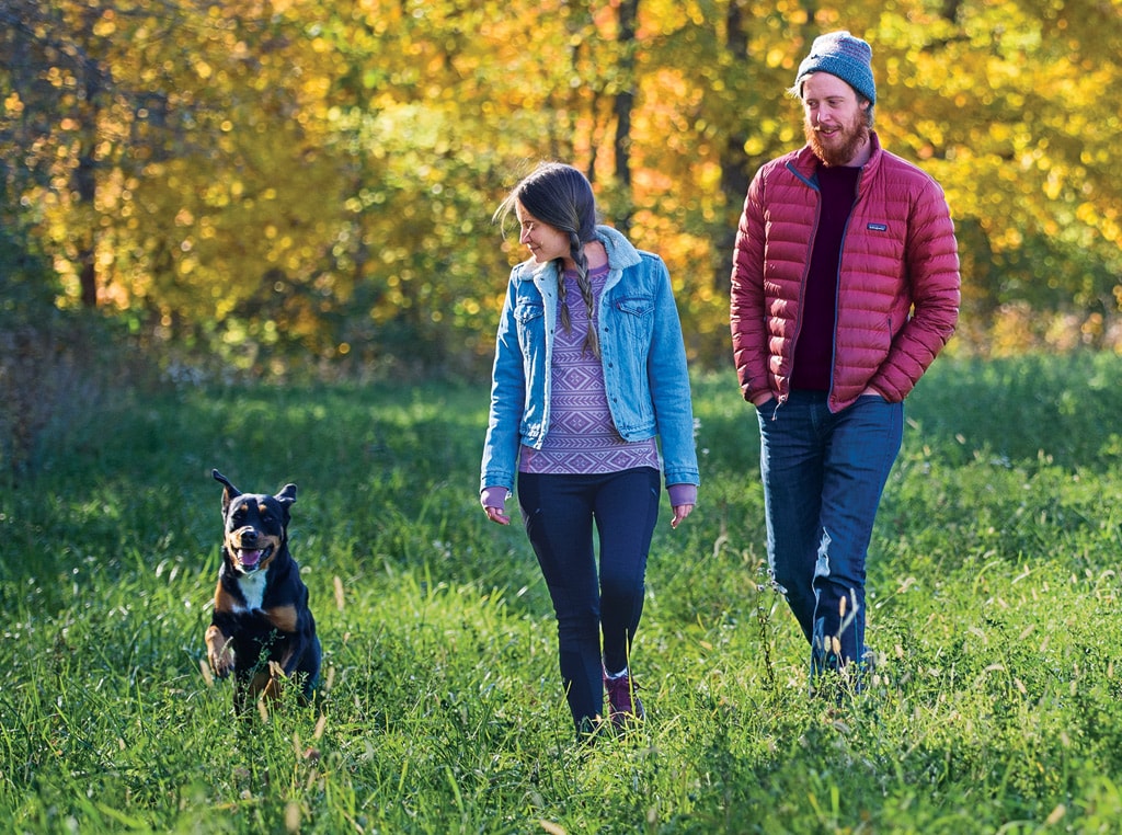 Couple walking a dog