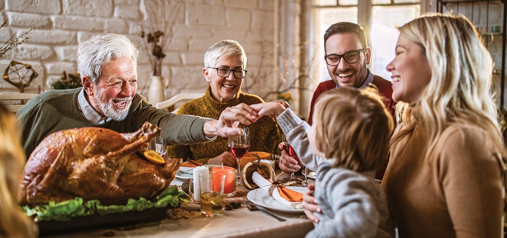 family holding hands over a meal