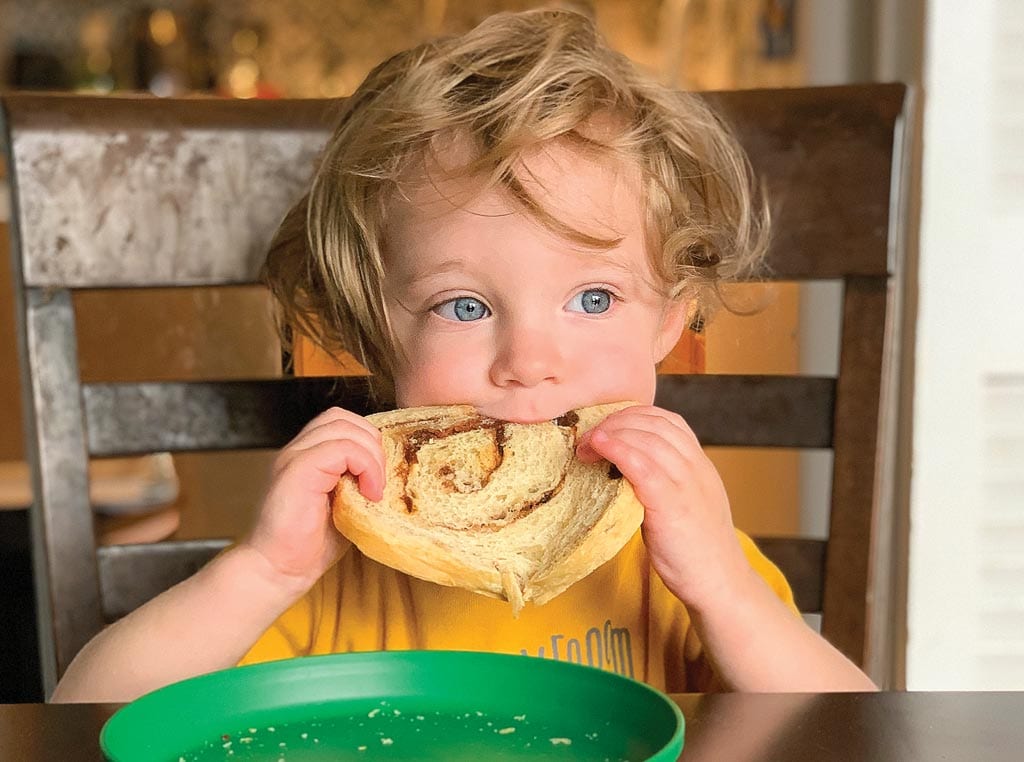 child eating bread