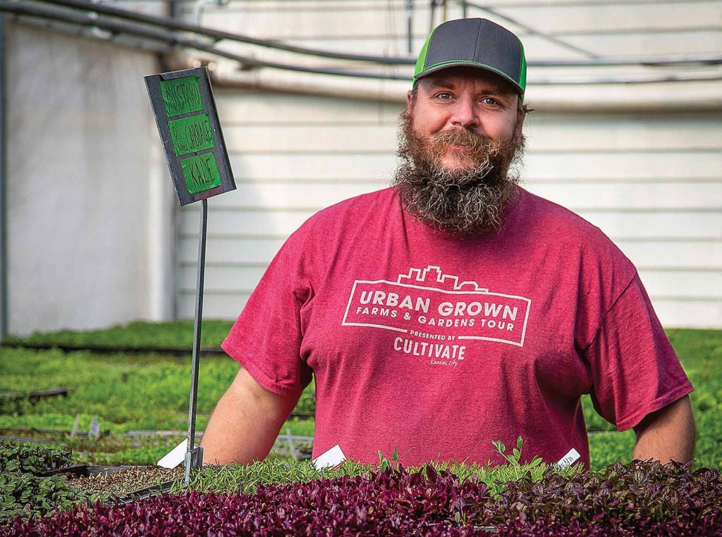 Greg Garvos surrounded by microgreens