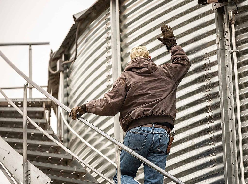 man by grain tank