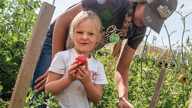 child with tomato