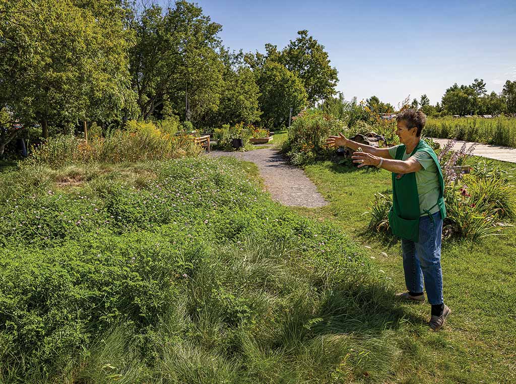 person gesturing at garden