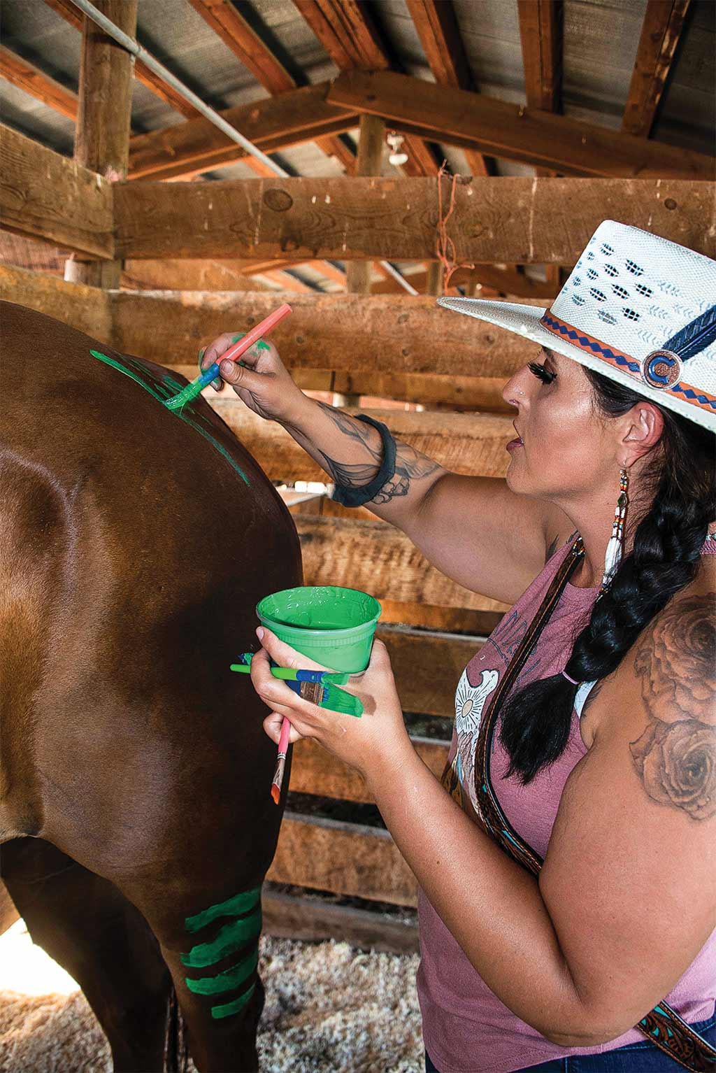 Woman painting horse