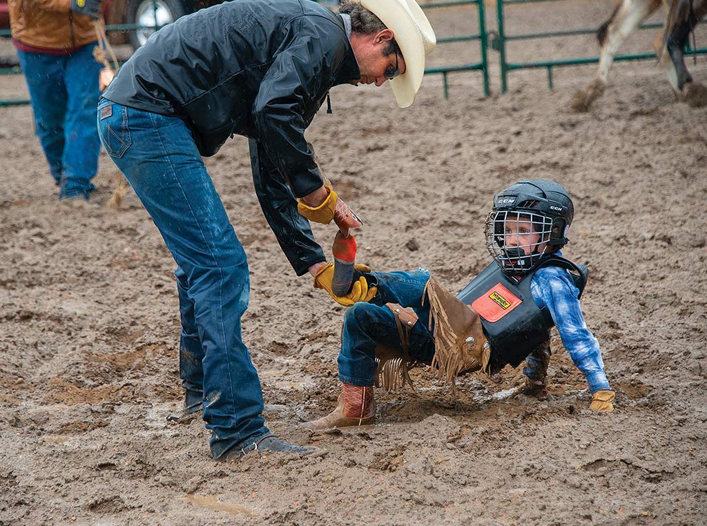 Man checking on little boy after rodeo accident