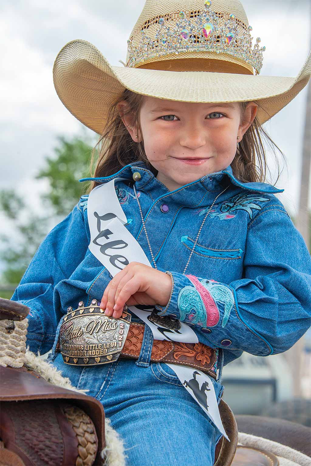 Little girl showing her belt buckle