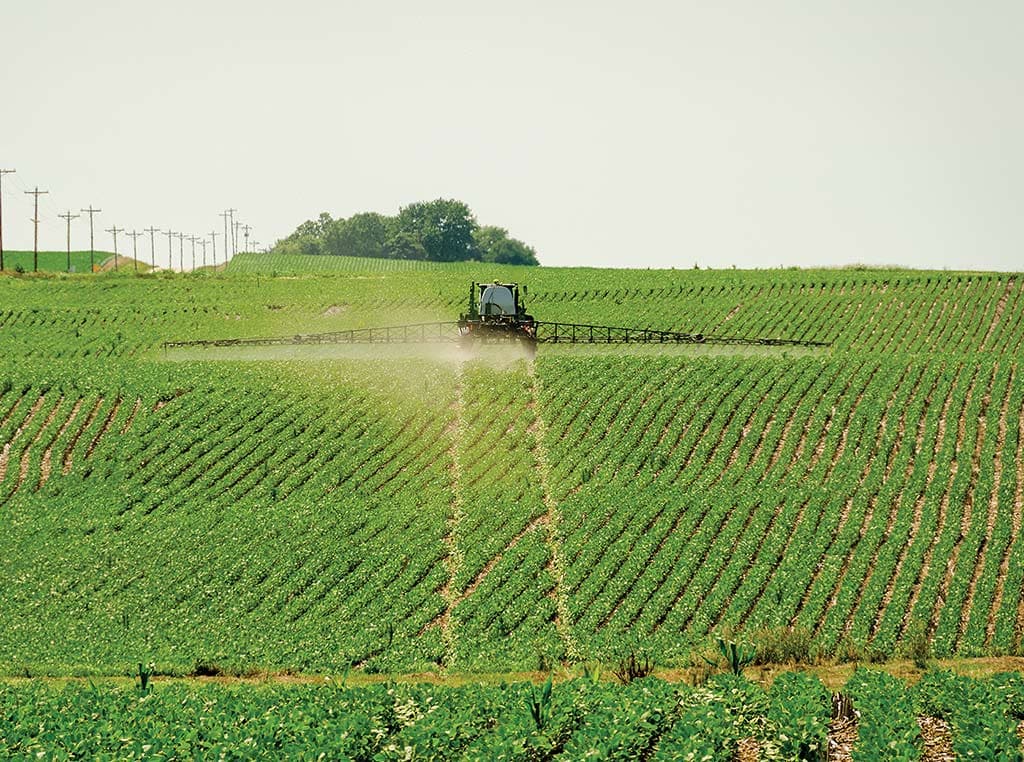 tractor spraying a field of crops