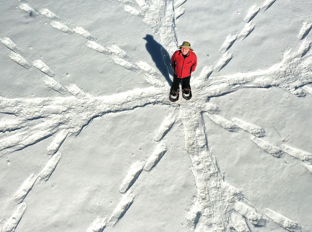 man making snow art