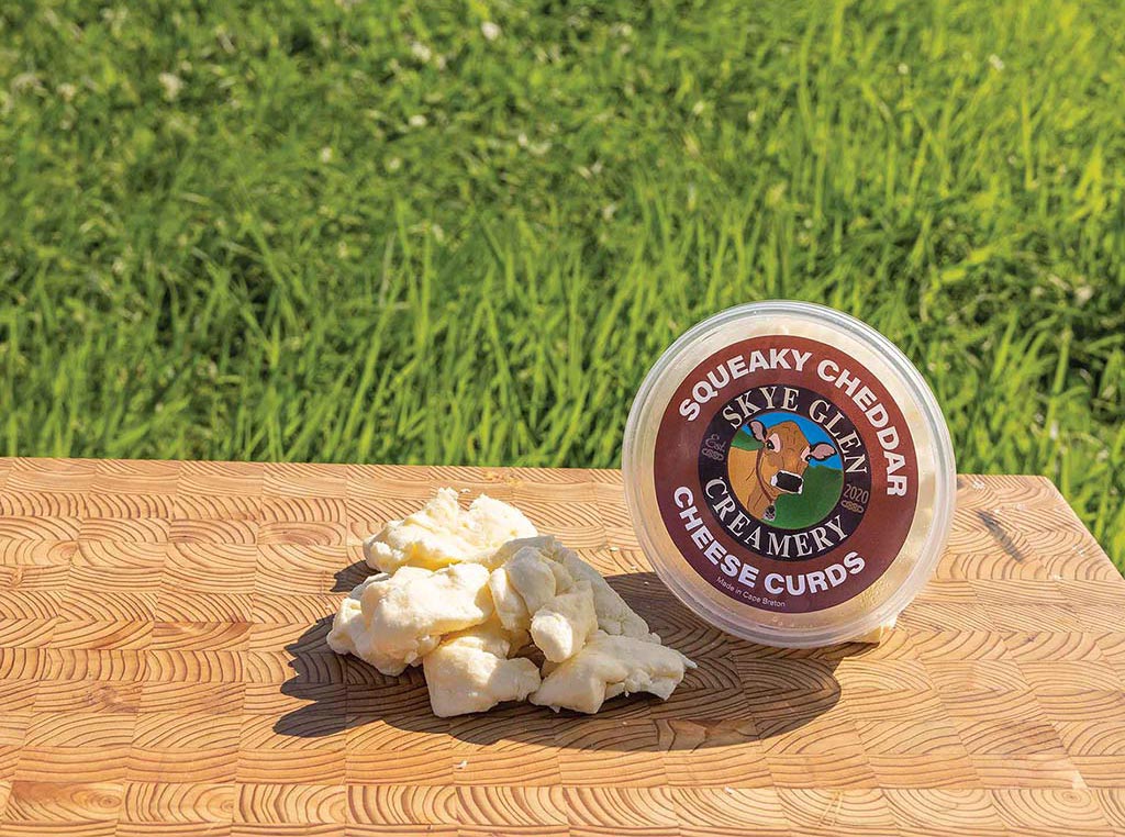 container of cheese curds on wooden table outsid