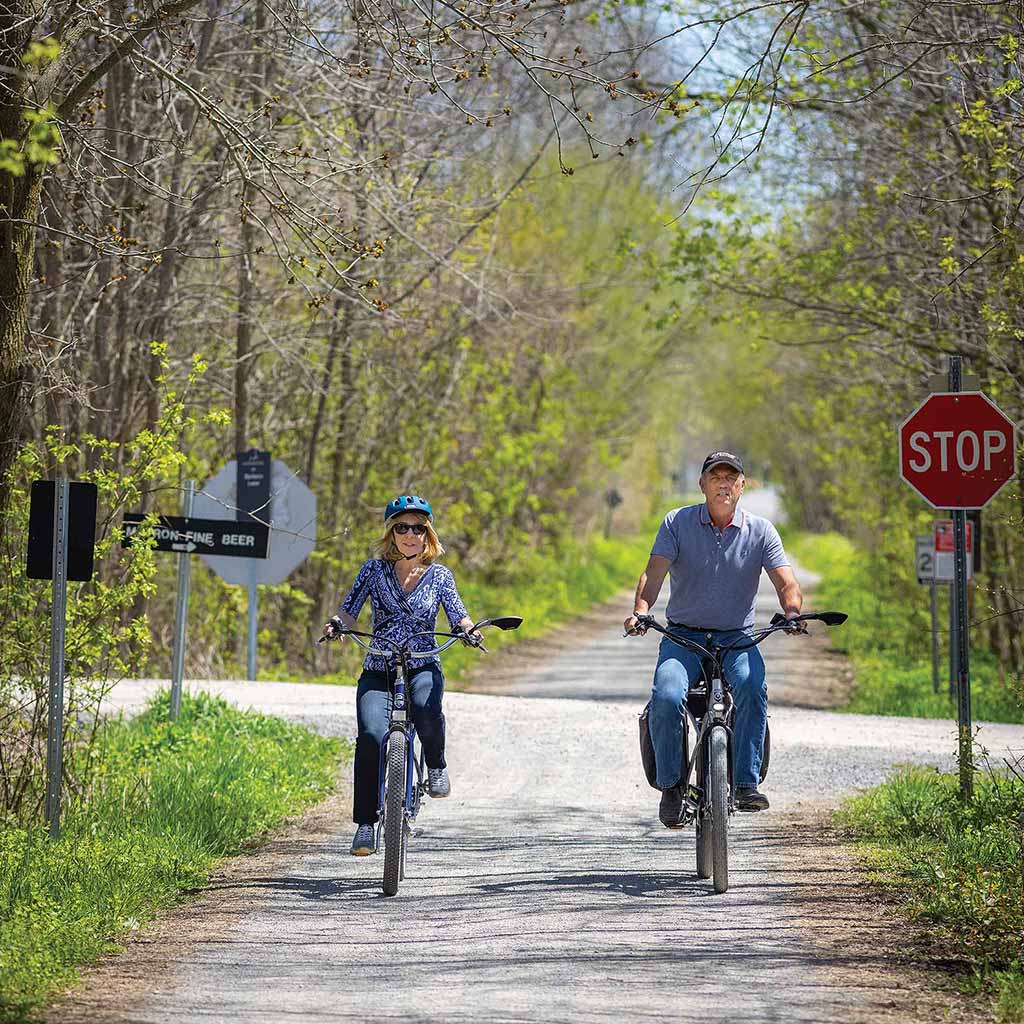 Two people riding bike deals