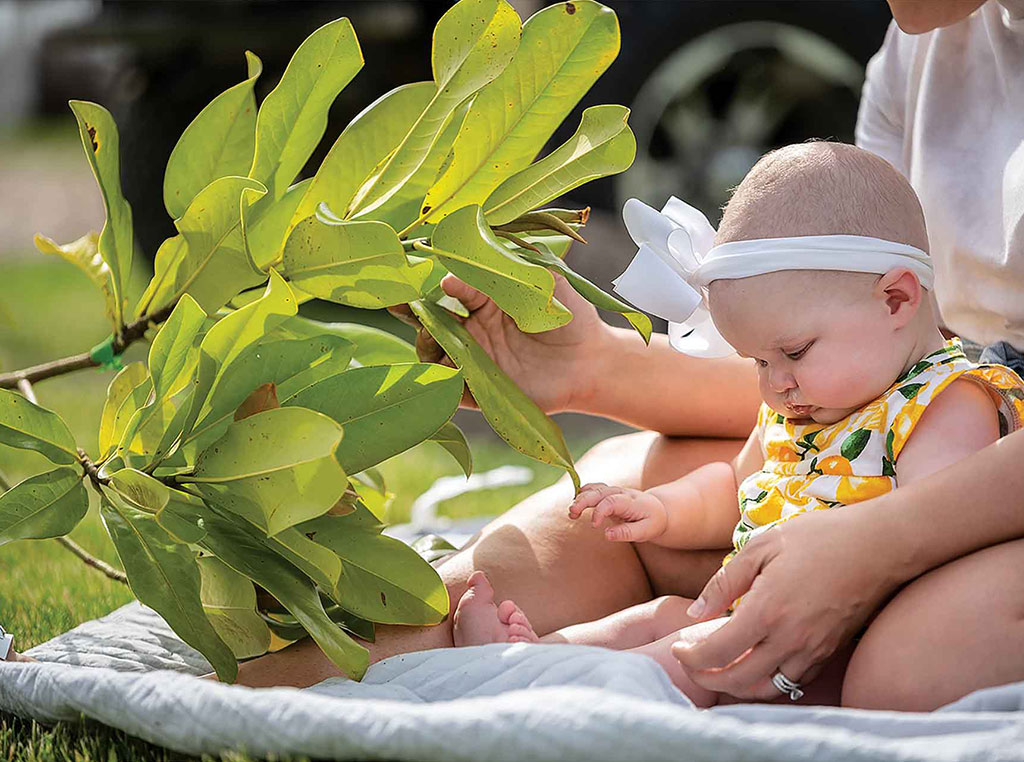 baby with magnolia branch