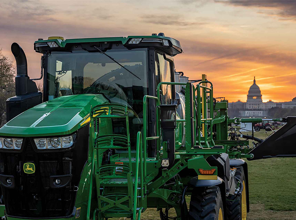 John Deere tractor with US Capitol Building in background at sunset