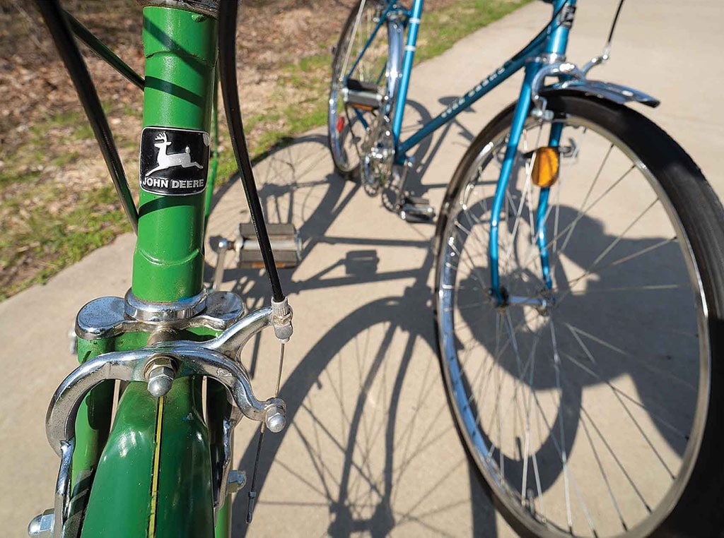 closeup of front of green John Deere bicycle
