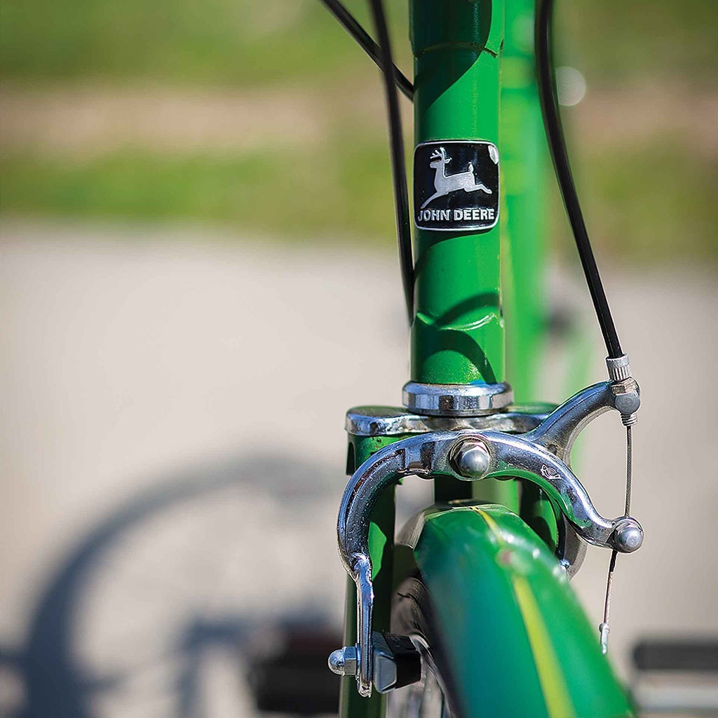 closeup of John Deere emblem on bicycle neck