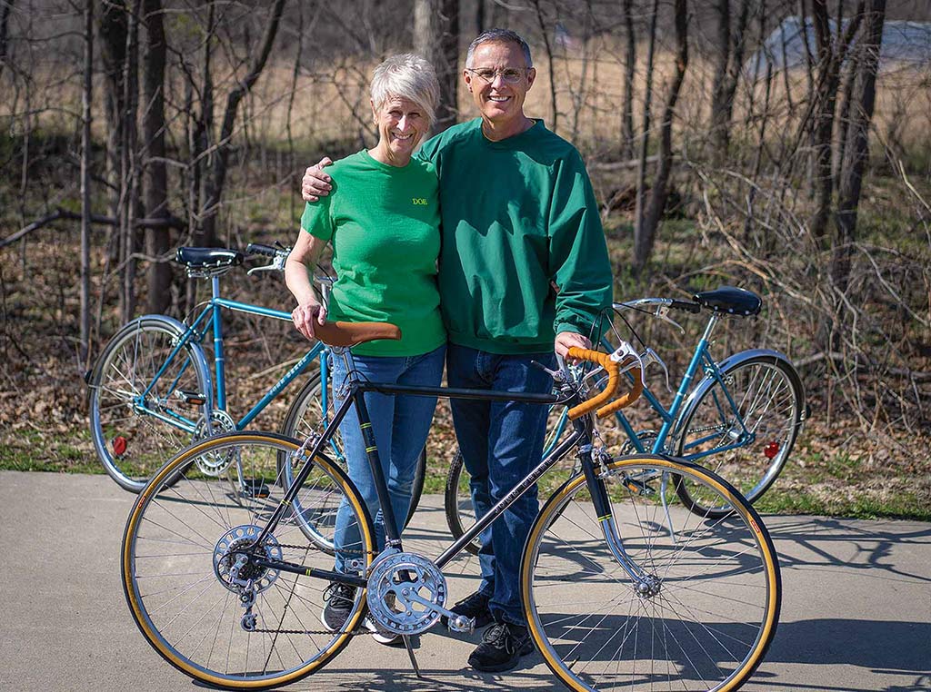 couple standing with John Deere bicycle