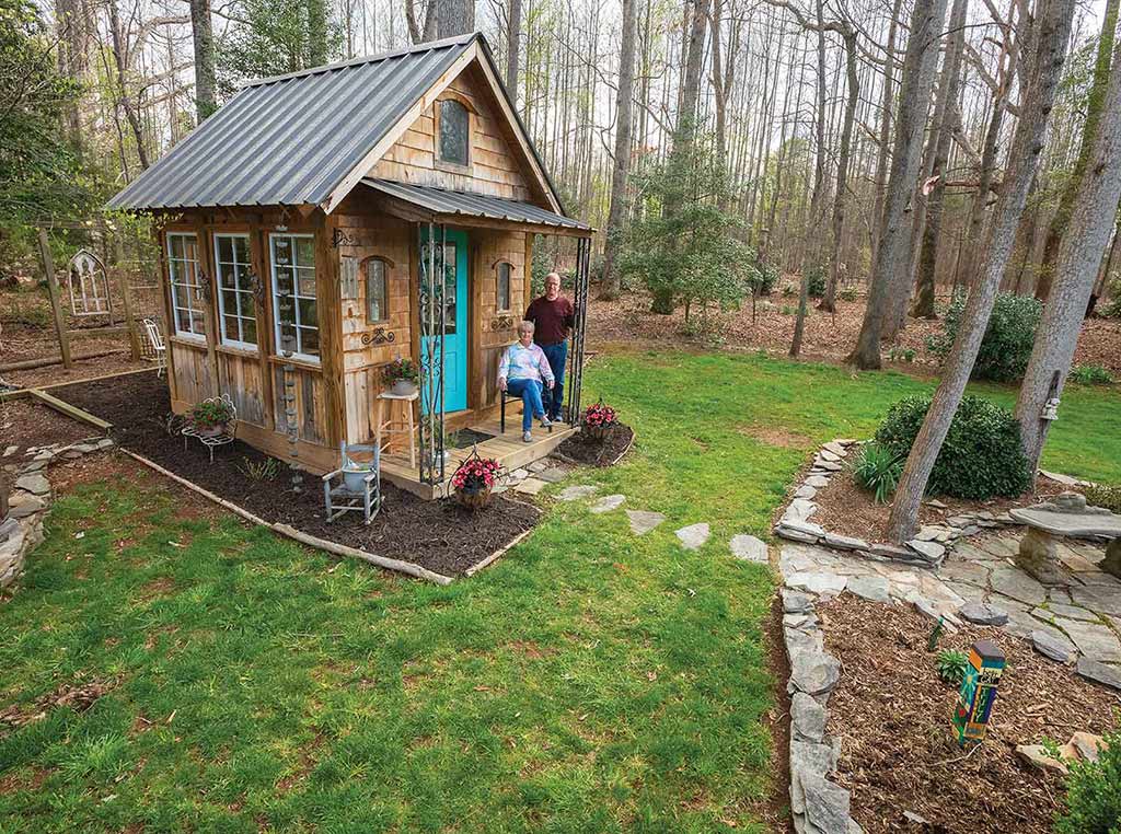 couple sitting in front of quaint shed