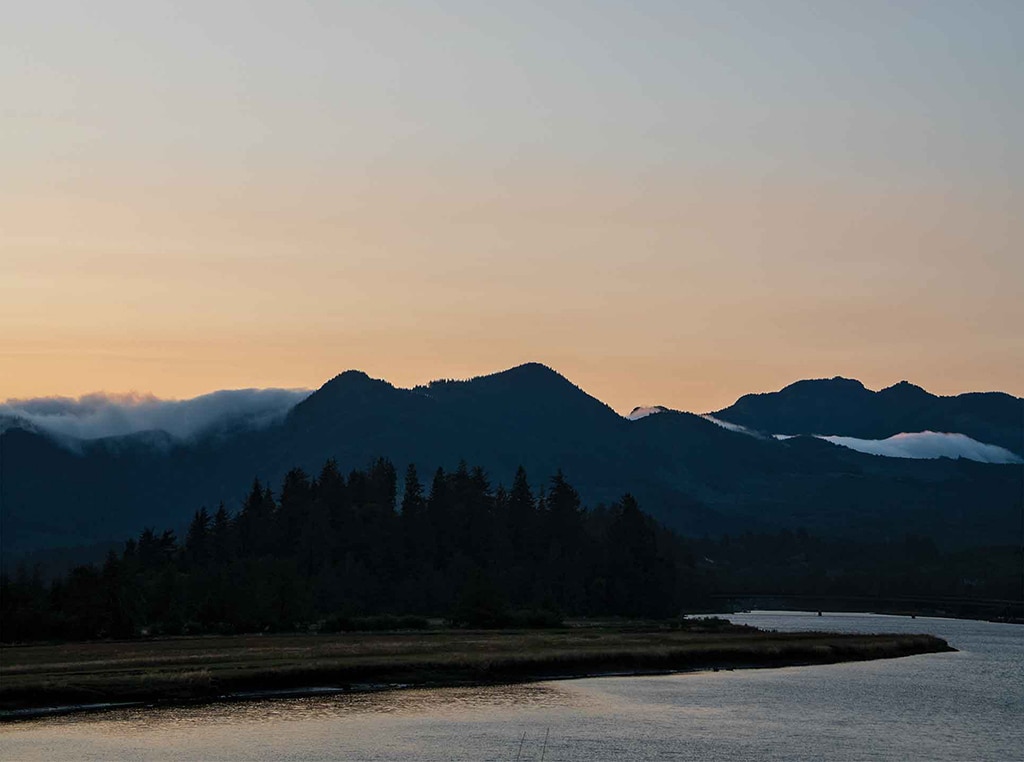 coastal mountain landscape topped with clouds at dawn