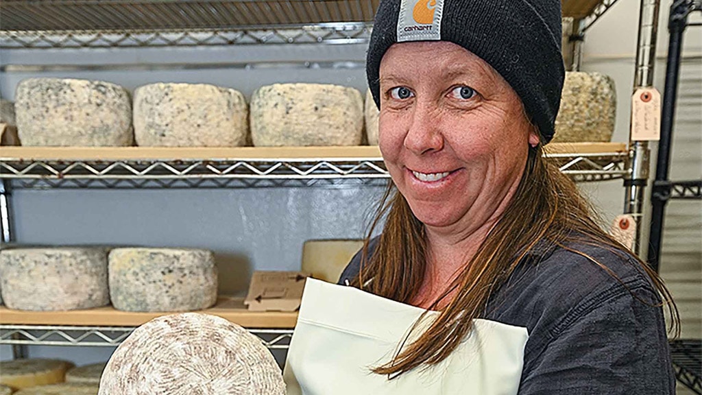 woman holding cheese wheel