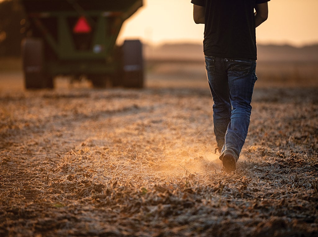 man walking kicking up dust