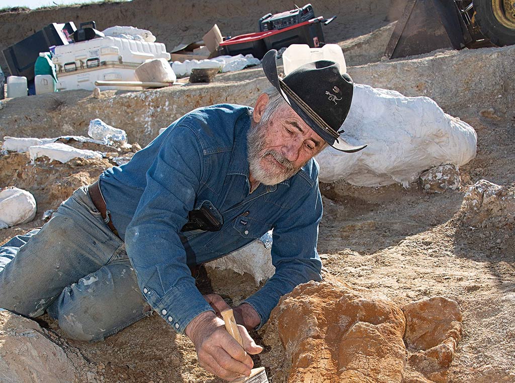 Rancher Don Wyrick, pictured with a Brachiosaurus femur