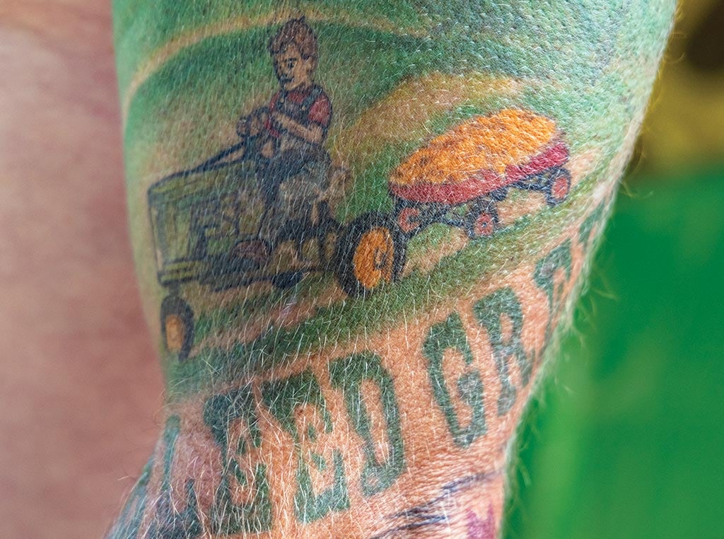 upper arm tattoo that reads bleed Deere