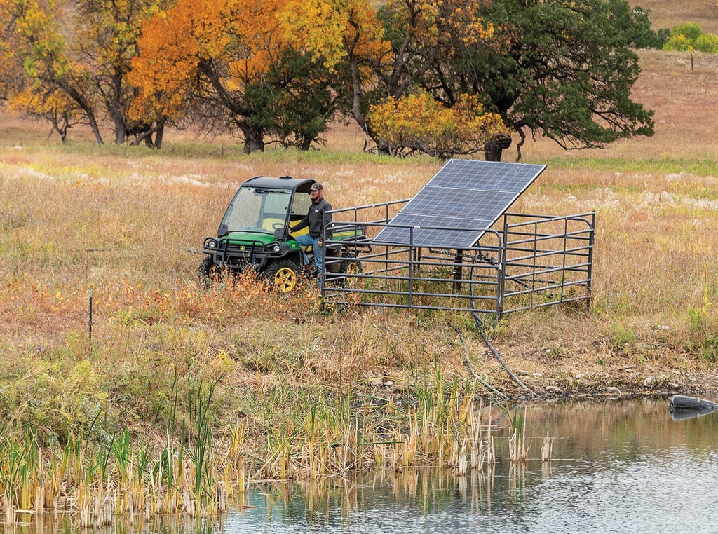 John Deere Gator utility vehicle next to solar panel