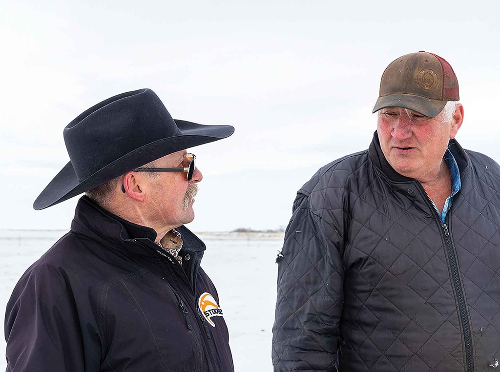 cattle ranchers standing in the snow