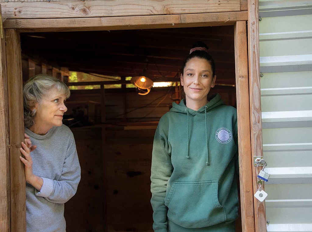 mother and daughter livestock farmers standing in doorway