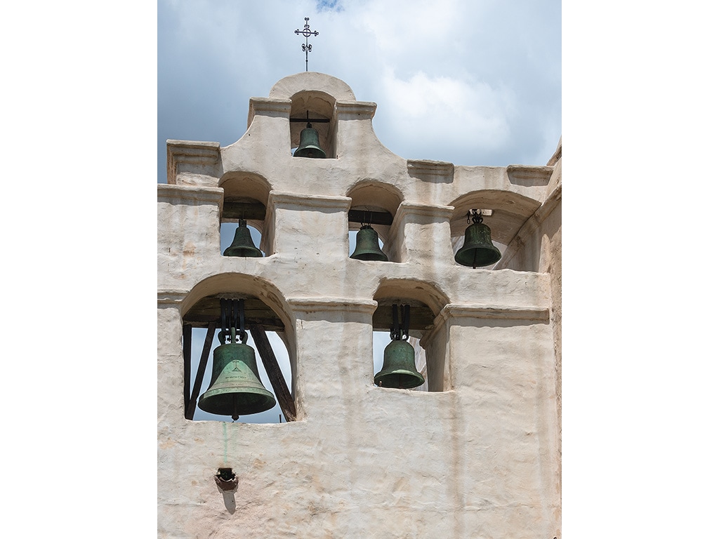  bells inset into white terra cotta wall