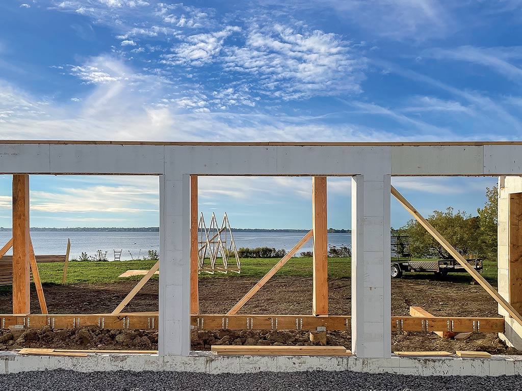 Building being constructed on edge of river