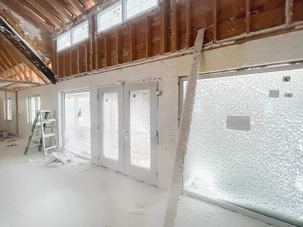 inside of a newly built house where snow has blown into all of the walls and floor