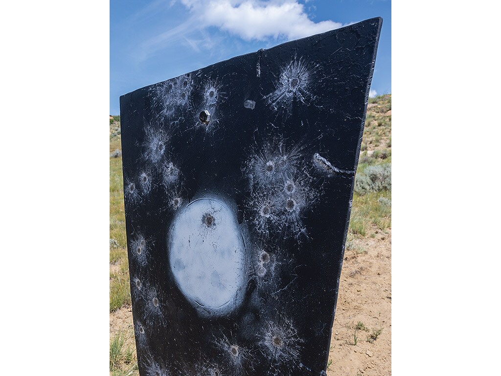 metal target with rifle bullet holes through it