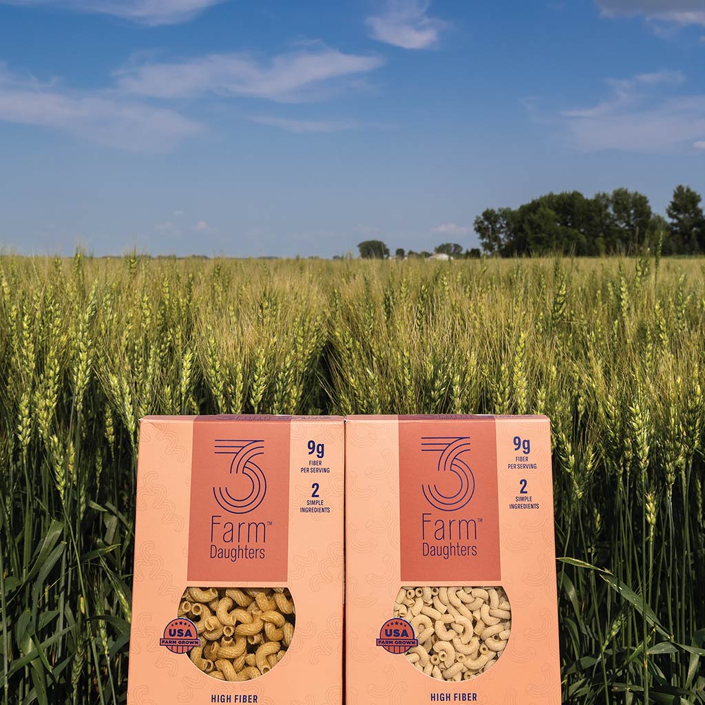 Pasta packages in front of wheat field