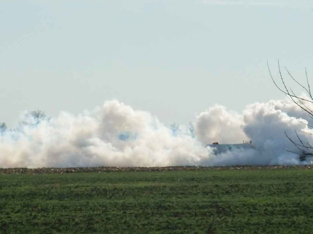 plumes of steam emanating from the ground on the horizon