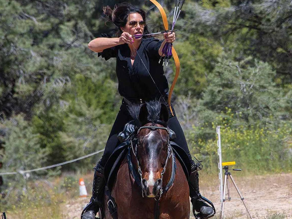 archer on horseback drawing an arrow on a bow