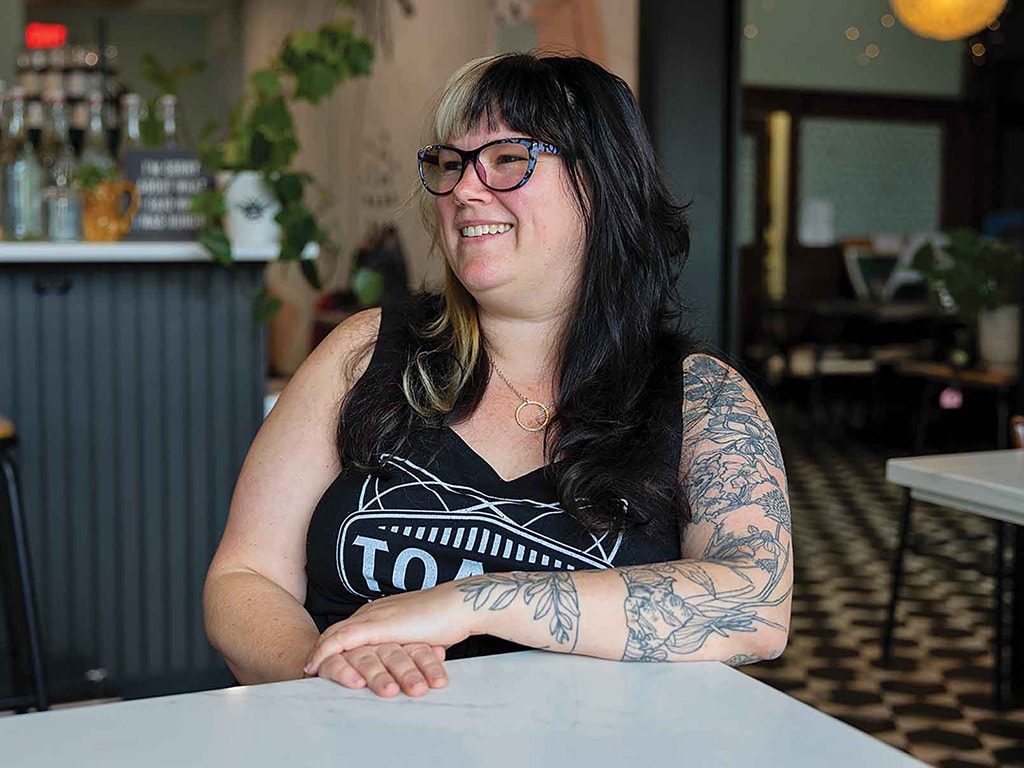 Person smiling leaning on a white marble table