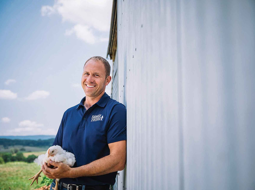 man holding chicken