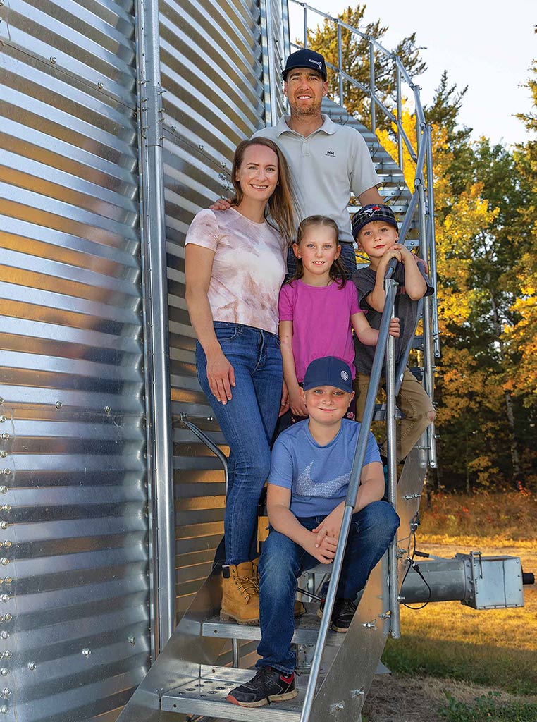 farmer family on stairwell next to silo