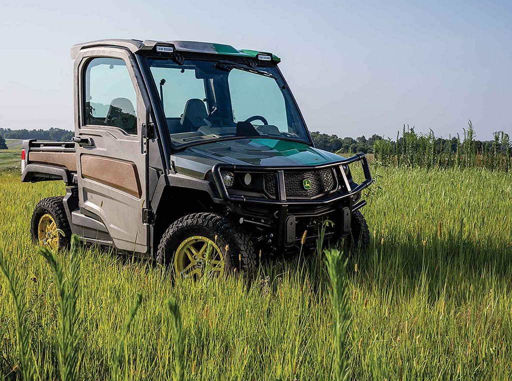 Deere Gator utility vehicle made of recycled materials in field