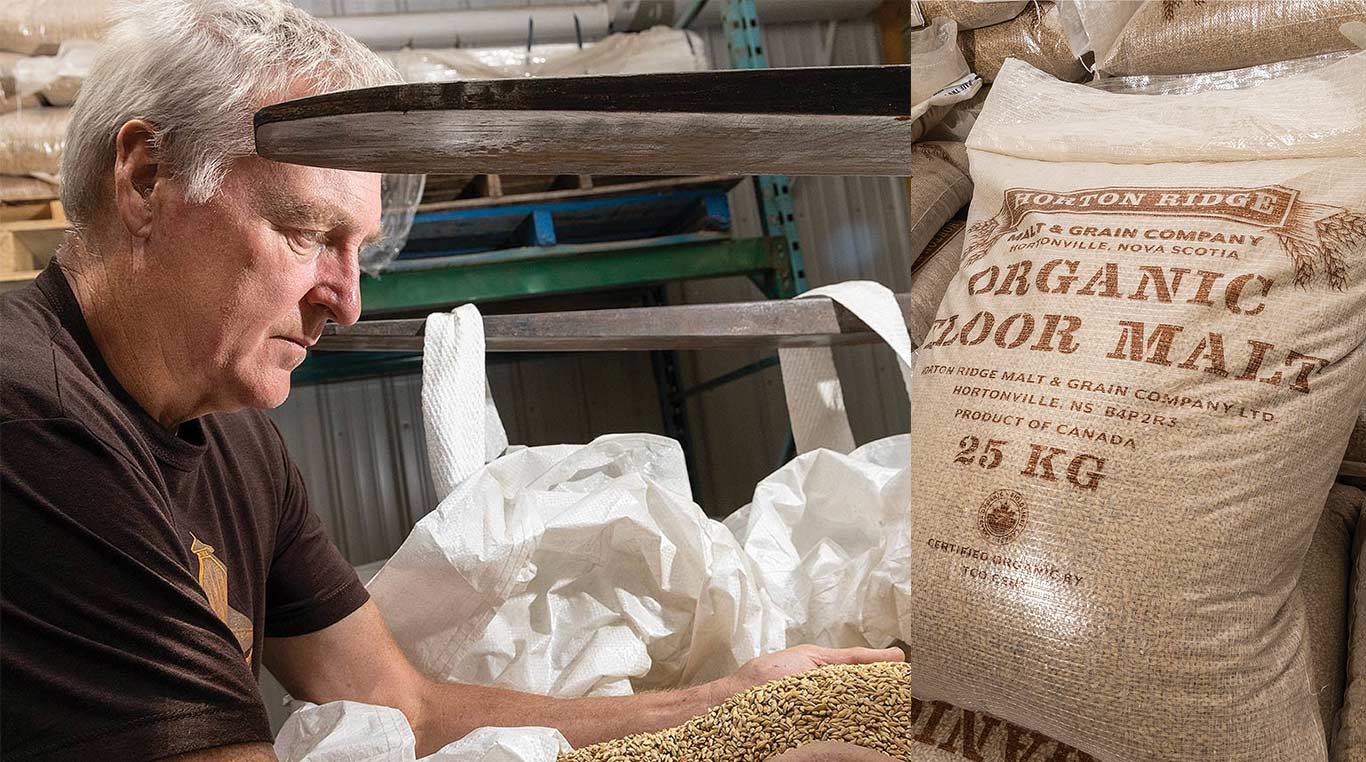 a man holding barley next to a bag of malt