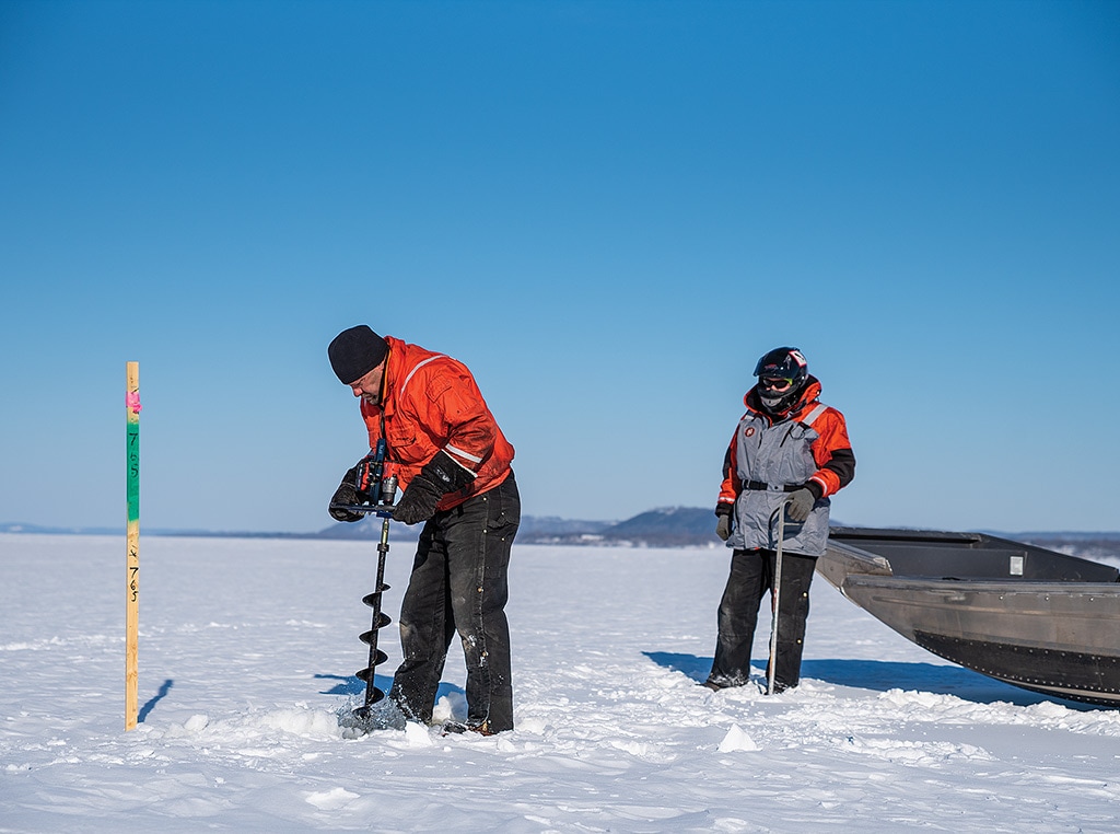 workers drilling ice