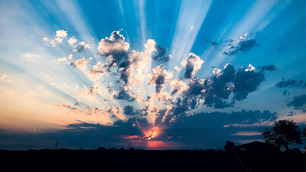 sunrays shining through a cloudy sky